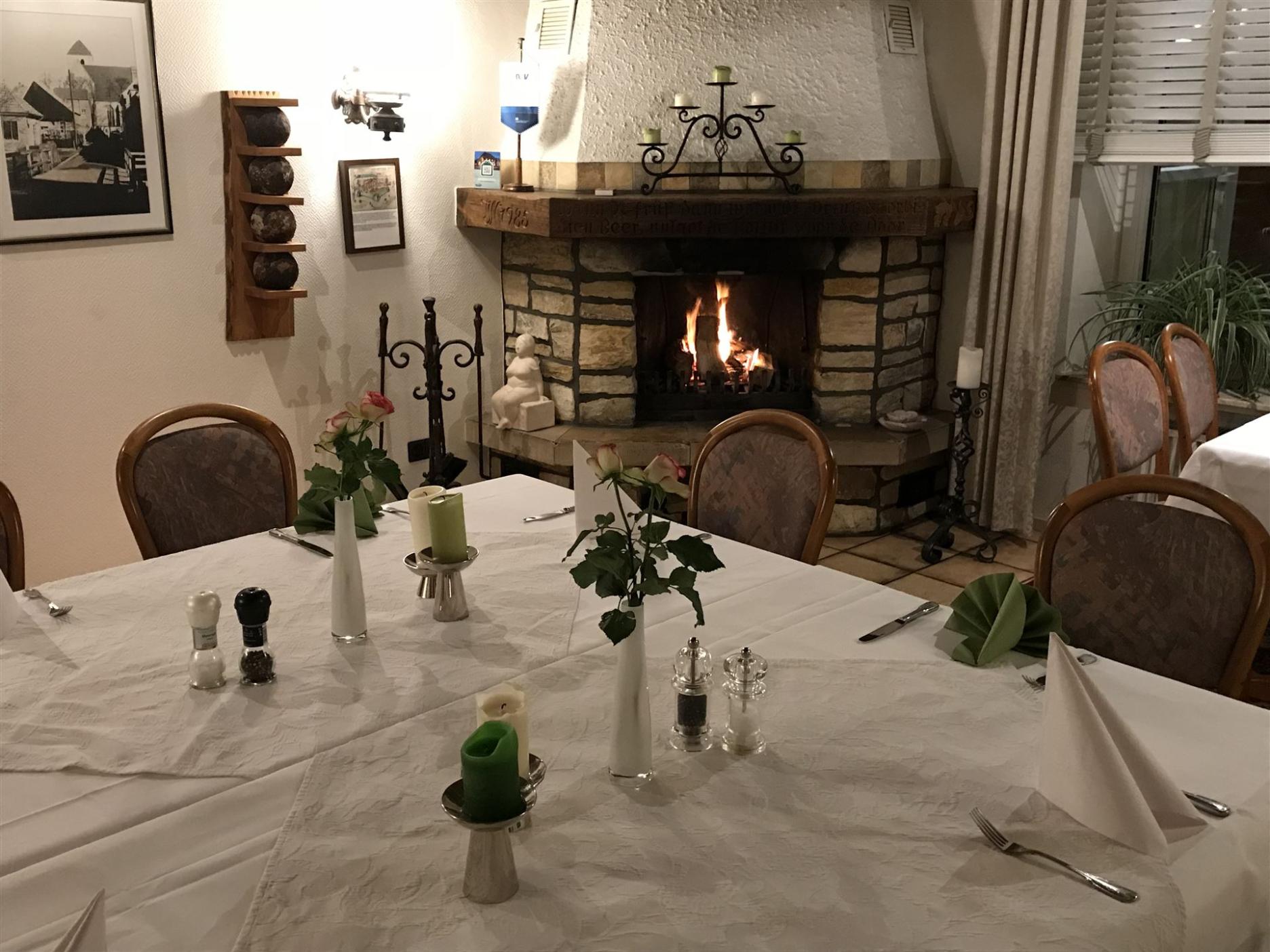 Photo of the club room with a burning fireplace.