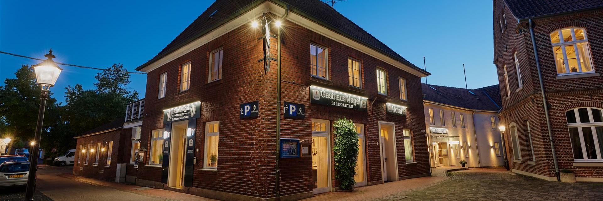 Exterior view of the hotel in the evening, seen from the church.