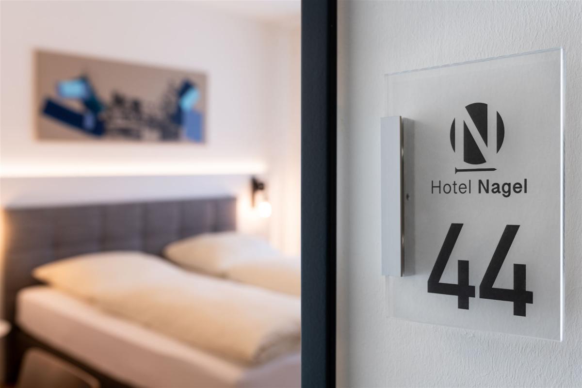 View of a roomnumber next to the opened door. You can see a comfort double room