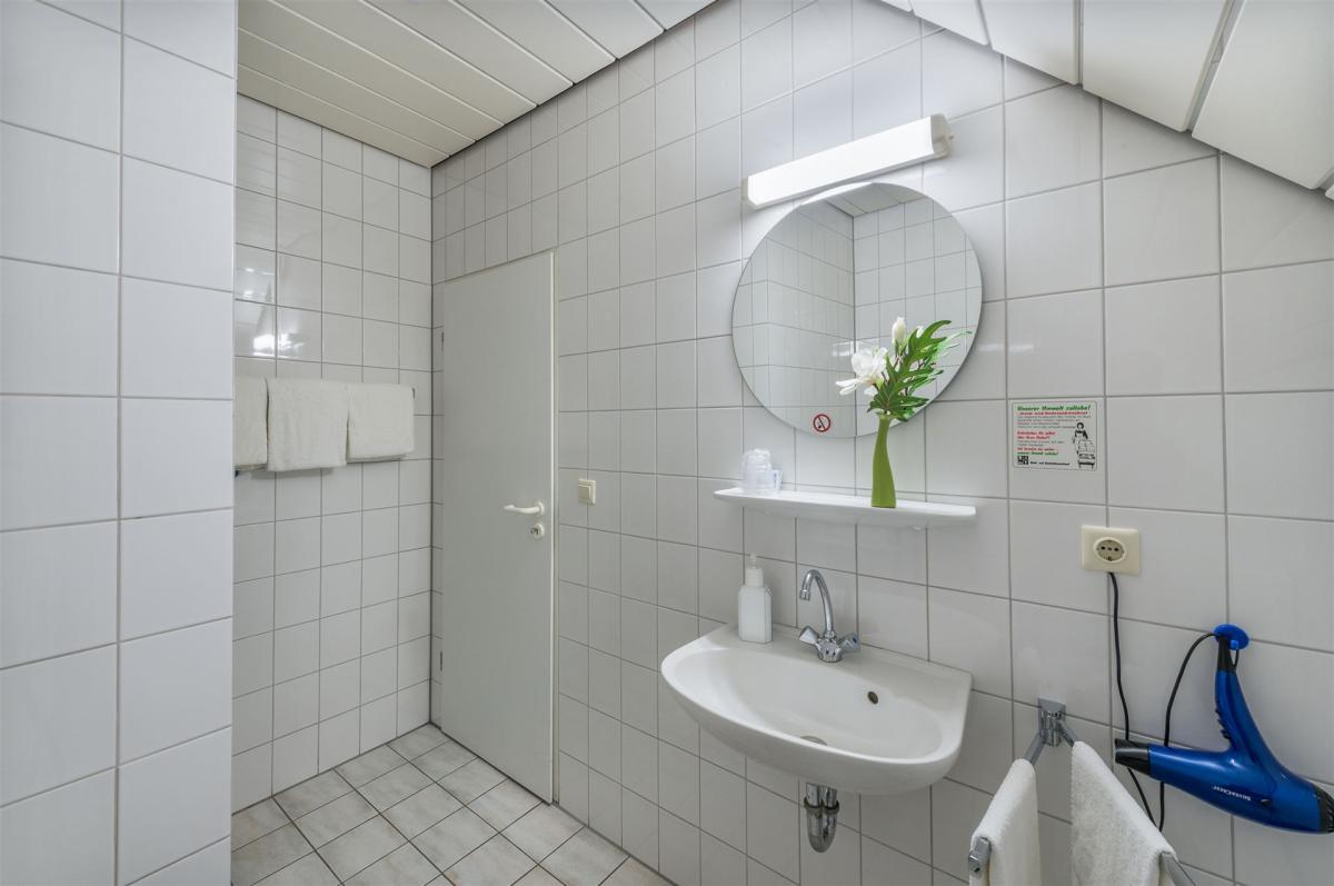 The picture shows  the bathroom in an economy double room.