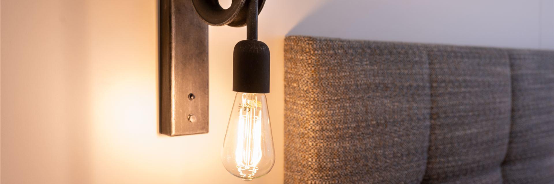 Lit wall lamp in the comfort room.
