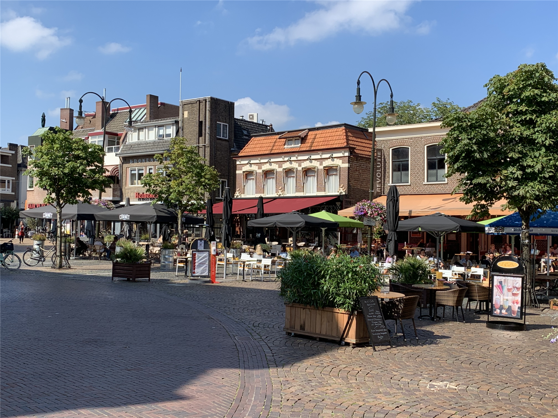 View of a row of houses with cafés around the church in Winterswijk.